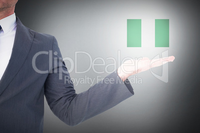 Composite image of businessman with his hand out