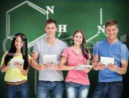 Composite image of a group of people standing with their tablets