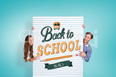 Composite image of happy young couple with blank board