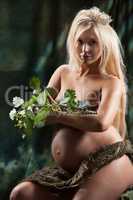 Young Pregnant Woman With Green Leaves