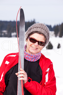 Woman with cross-country skiing in winter landscape