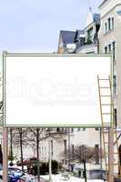 Blank billboard in front of multi-family house