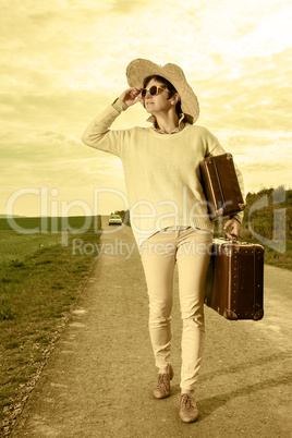 Woman running on the road and wearing holiday suitcase