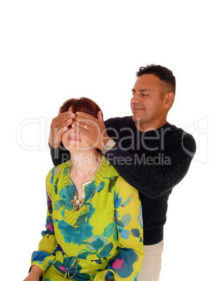 Husband putting his hands over the wife's eye's.