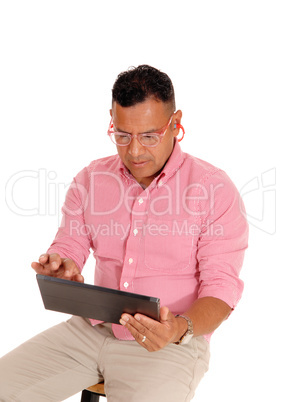 Closeup of man working on tablet pc.