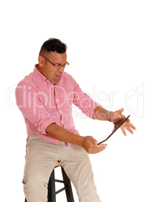 Man screaming at his tablet computer. Man screaming at his tablet computer.