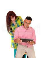 Couple playing with tablet computer.