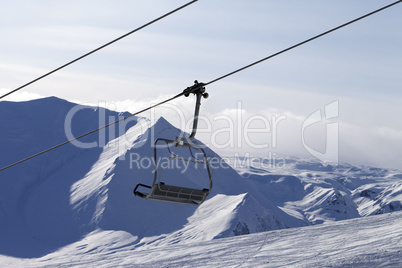 Chair lift and mountains in evening