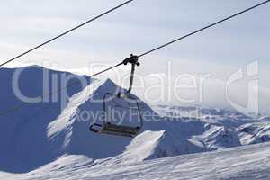 Chair lift and mountains in evening