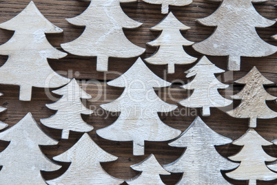 Close Up Of Christmas Trees On Wooden Background