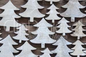 Close Up Of Christmas Trees On Wooden Background
