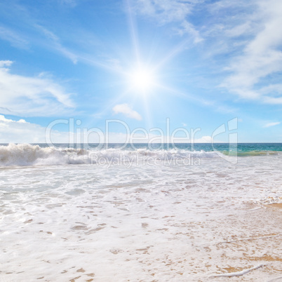 ocean, sandy beach and blue sky