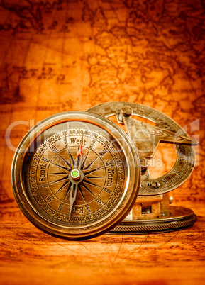 Vintage compass lies on an ancient world map.