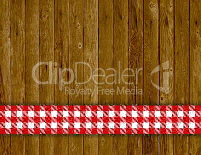 Rustikaler Holz Hintergrund mit rot weisser Tischdecke