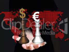 Hand holding chess pieces with dollar and euro signs with world map