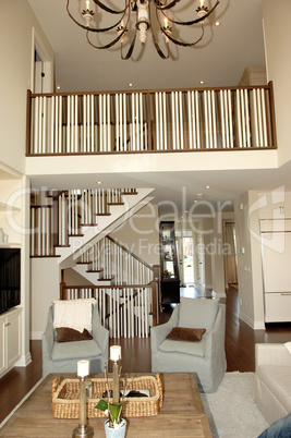 Elegant roomy living room with staircase.