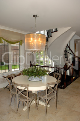 Dining area in a new house whit staircase.