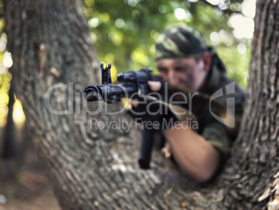 soldier shooting from a Kalashnikov closeup