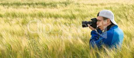 Photographer in a field of barley