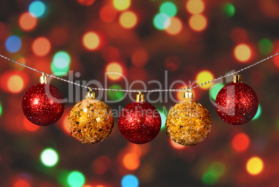 Golden and red christmas ball on the defocused background