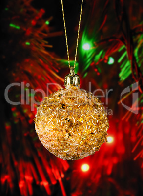 Golden christmas ball on the defocused background