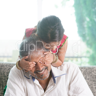 Girl surprising her father by covering daddy eyes