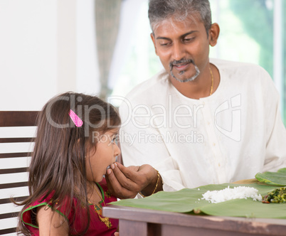 Father feeding child