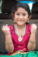 Excited Indian girl sitting in car