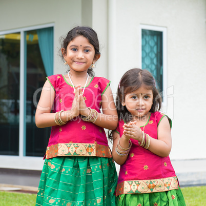 Cute Indian girls in sari greeting