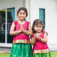 Cute Indian girls in sari greeting