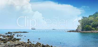 Small lagoon and sailboat on the horizon