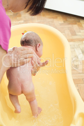 Bathing newborn baby.