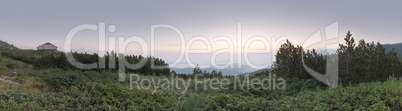 Sunrise in the mountain and hut. Panoramic image