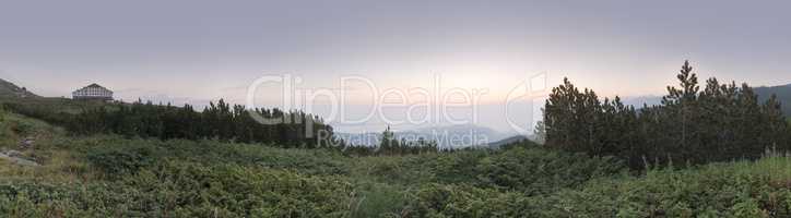 Sunrise in the mountain and hut. Panoramic image