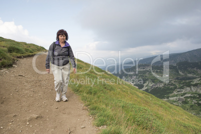 Senior woman walking in the mountain