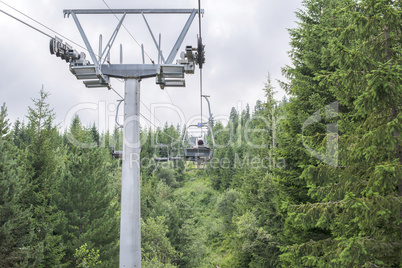 Lift in the mountain. Fir forest. Summer time