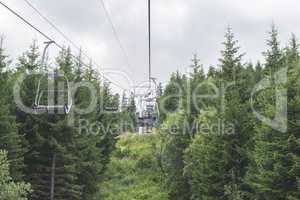 Lift in the mountain. Fir forest. Summer time