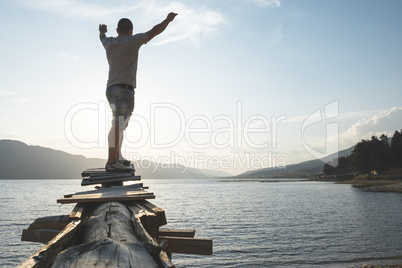 Boy in front of mountain lake