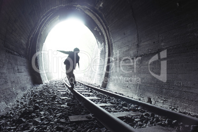 Child walking in railway tunnel