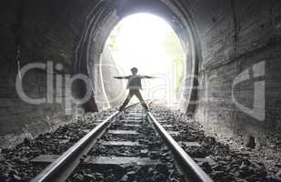 Child walking in railway tunnel