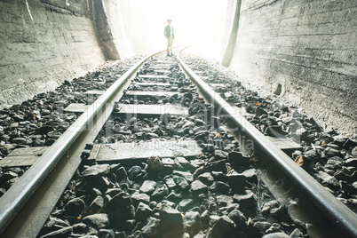 Child walking in railway tunnel