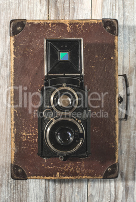 Vintage photo camera on wooden background