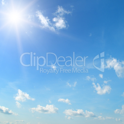 sun on blue sky with white clouds