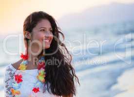 Beautiful young teenager with a white dress on the beach at suns