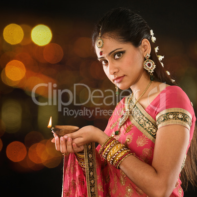 Indian girl hands holding diya lights
