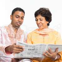 Indian family reading newspaper
