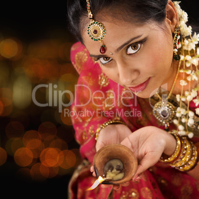 Indian woman hands holding diwali light