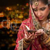 Indian girl hands holding diwali oil lamp