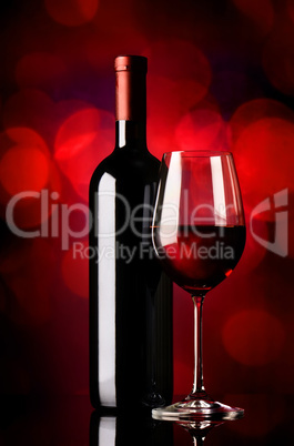 Bottle with wine on red