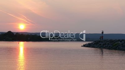 Couple viewing sunset at lake huron,canada,ontario